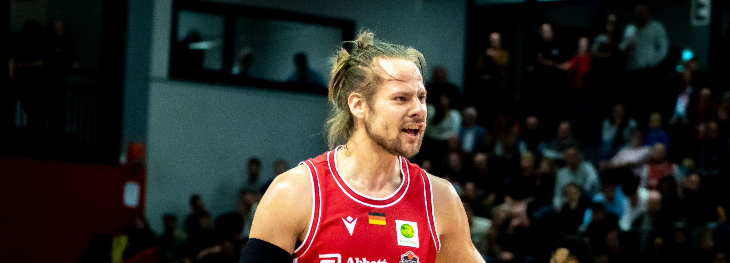 Basketballspielerin in rotem Trikot auf dem Spielfeld
