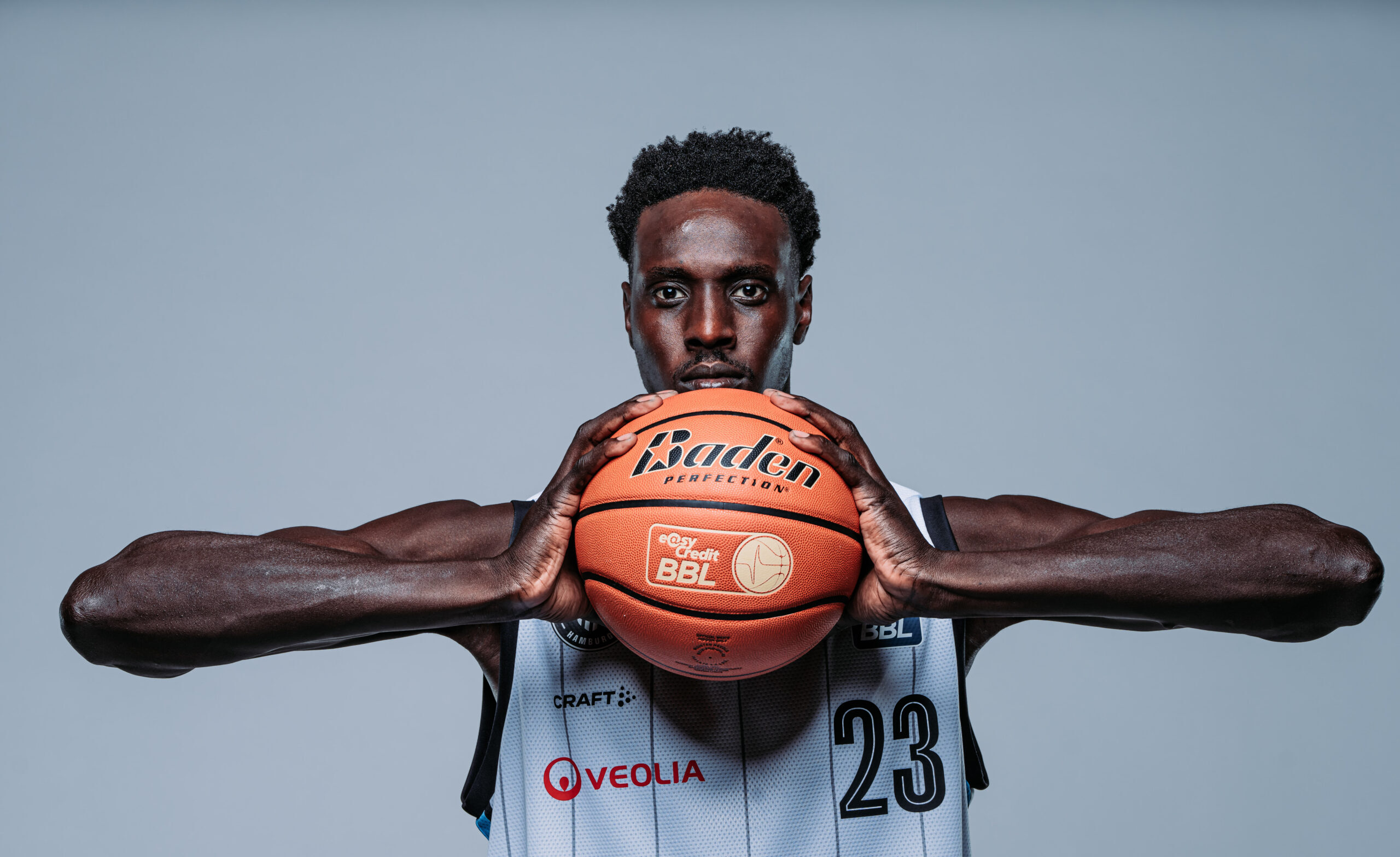 Kur Kuath in weißem Trikot hält Ball in den Händen