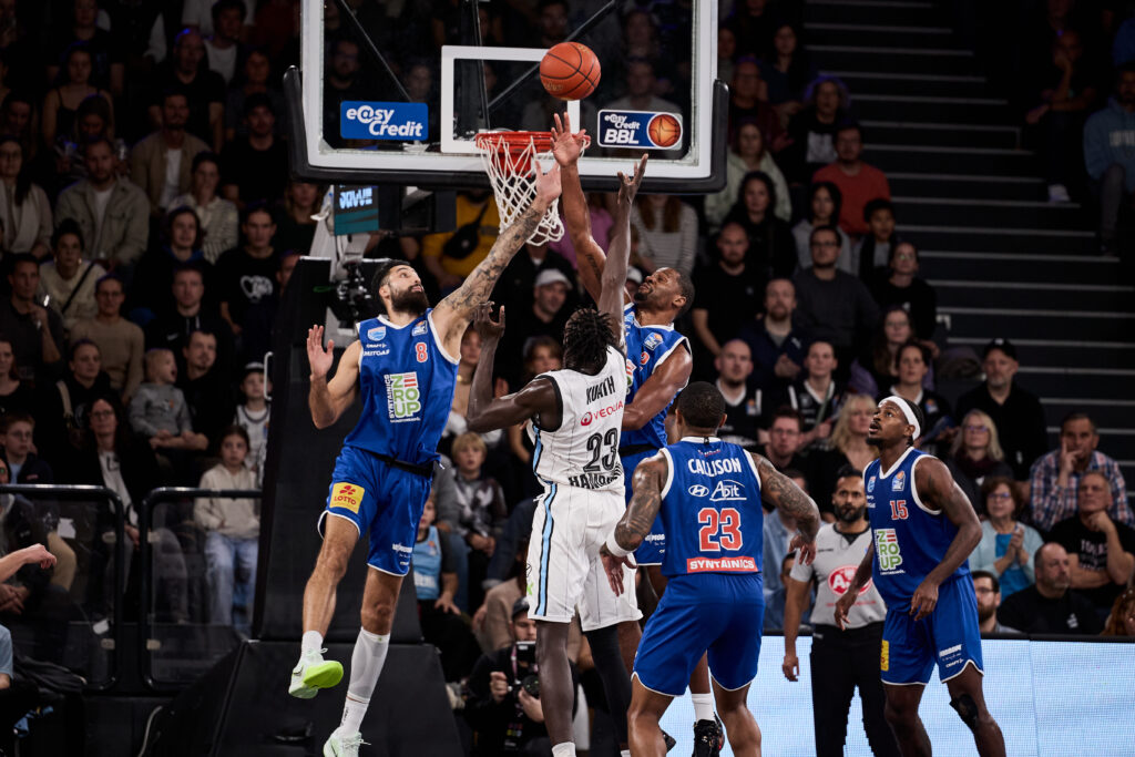 Kur Kuath unterm Korb gegen MBCs Martin Breunig und Tyren Johnson